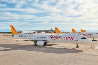 Яскраво-жовтий літак Pegasus Airlines на злітній смузі під час заходу сонця