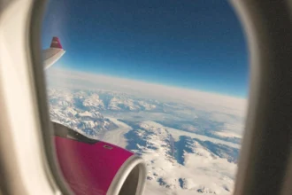 Яскраво-рожевий літак Wizz Air піднімається у небо в сонячний літній день